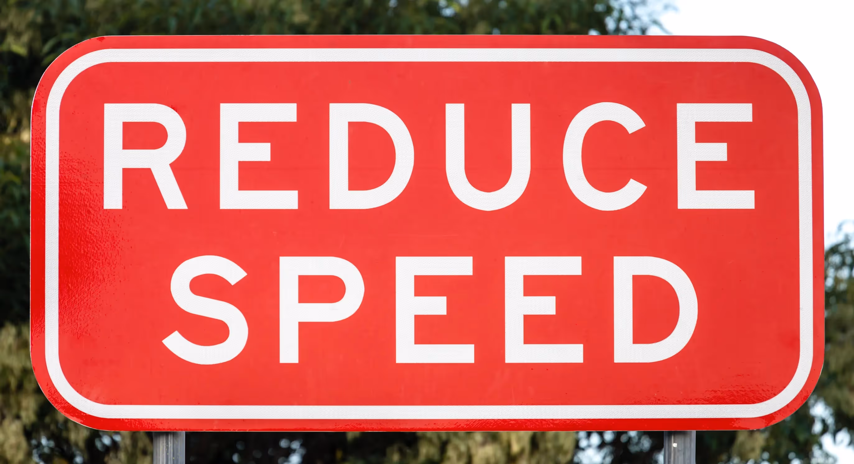 Road sign saying Reduce Speed