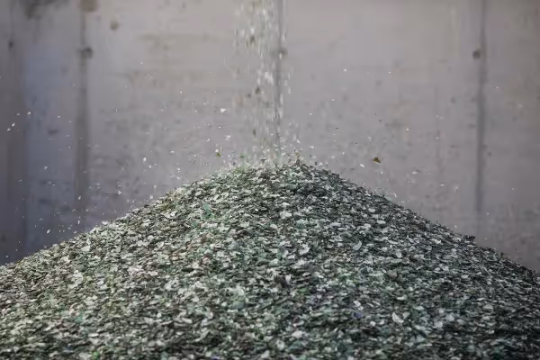 Recycled crushed glass pouring into a large pile