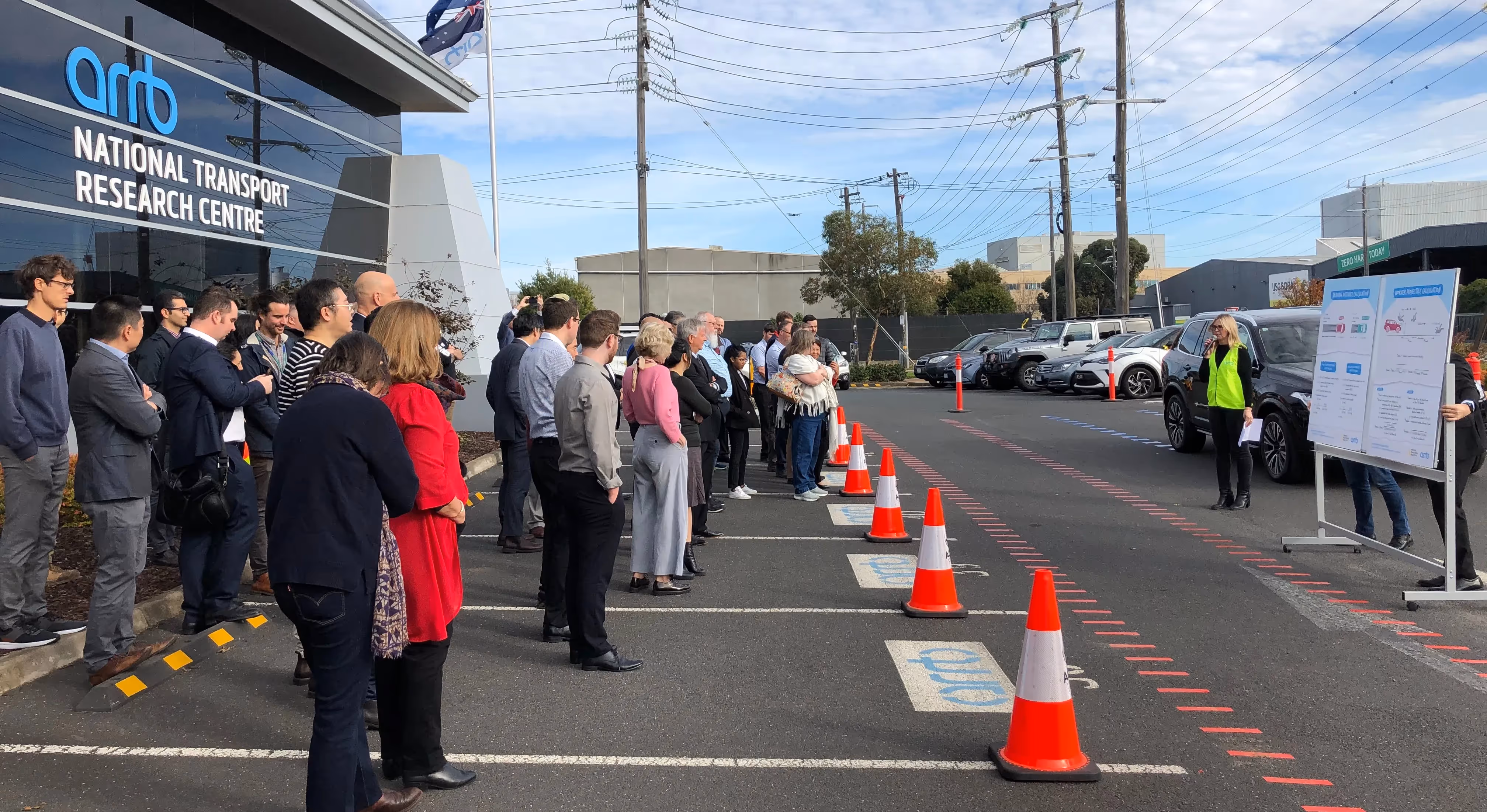 Group of people gathered around a crash scene investigation