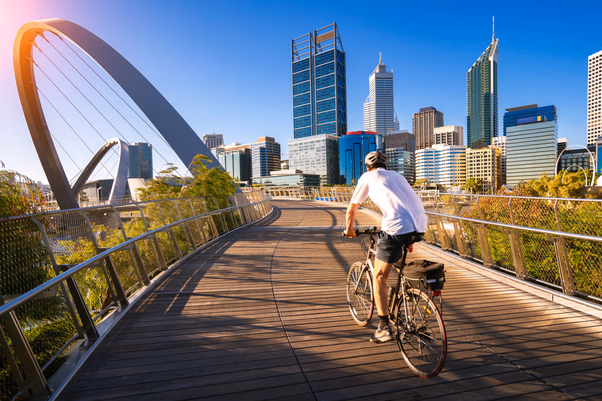 Person riding bike across a bridge in Perth Australia