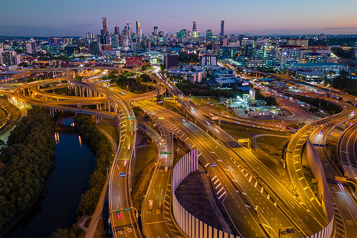 A city at duck with highways weaving around each other with a lot of car lights.