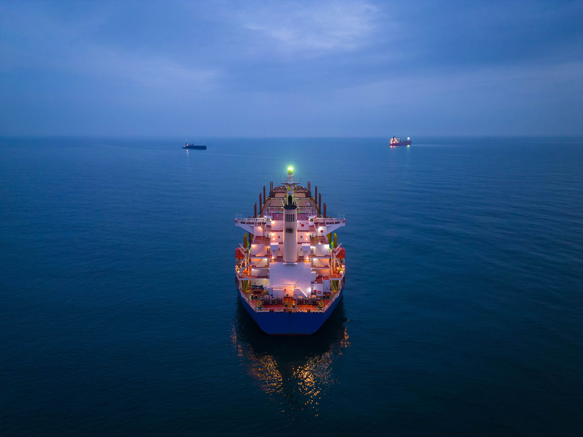 Large shipping transporting shipping containers across the ocean.