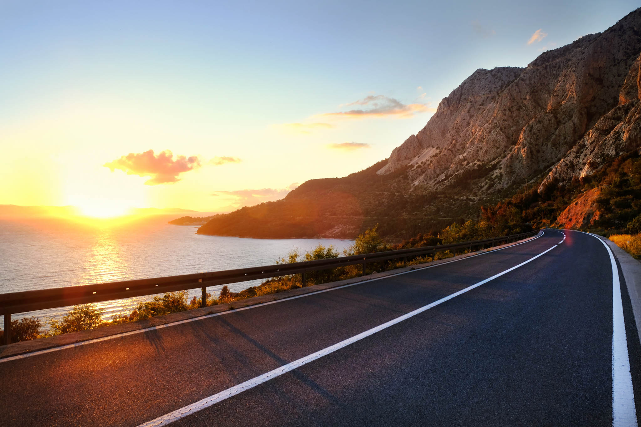 Sun setting over a winding sealed road in Australia