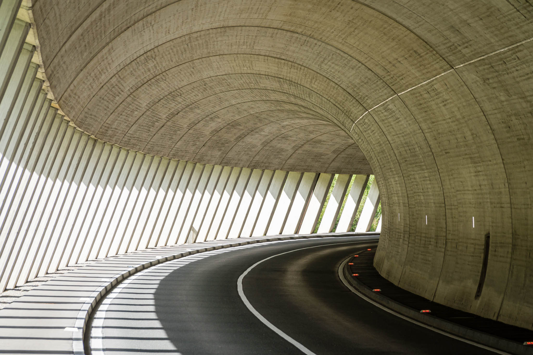 Wide tunnel winding around a corner.