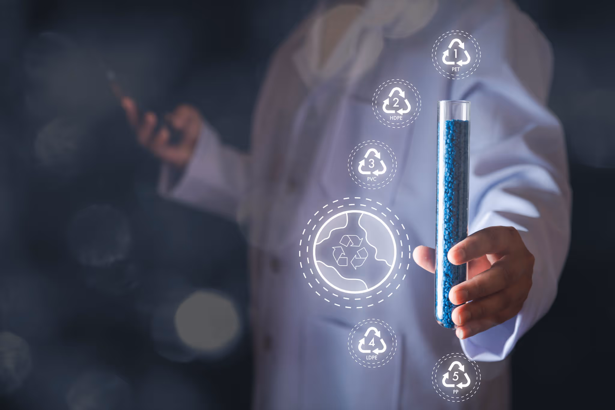 Person in a lab coat holding a tube of recycled materials