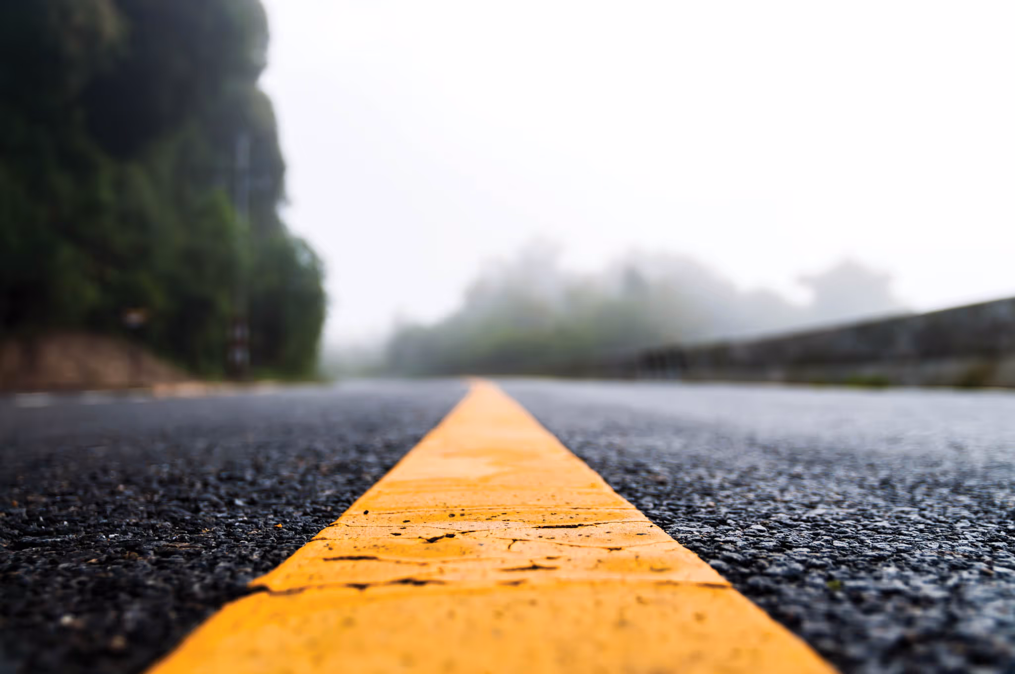 Close up of a road with yellow lines