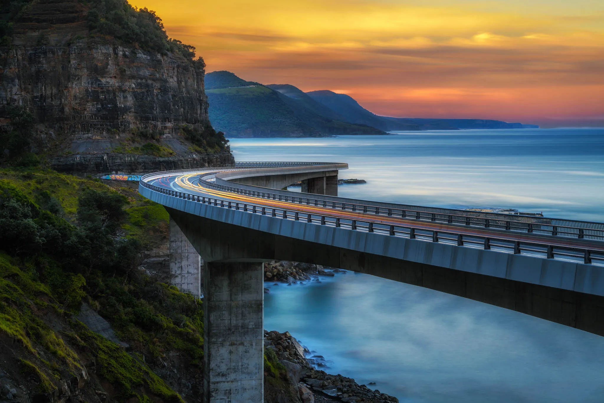 Bridge winding over Australian coastline.