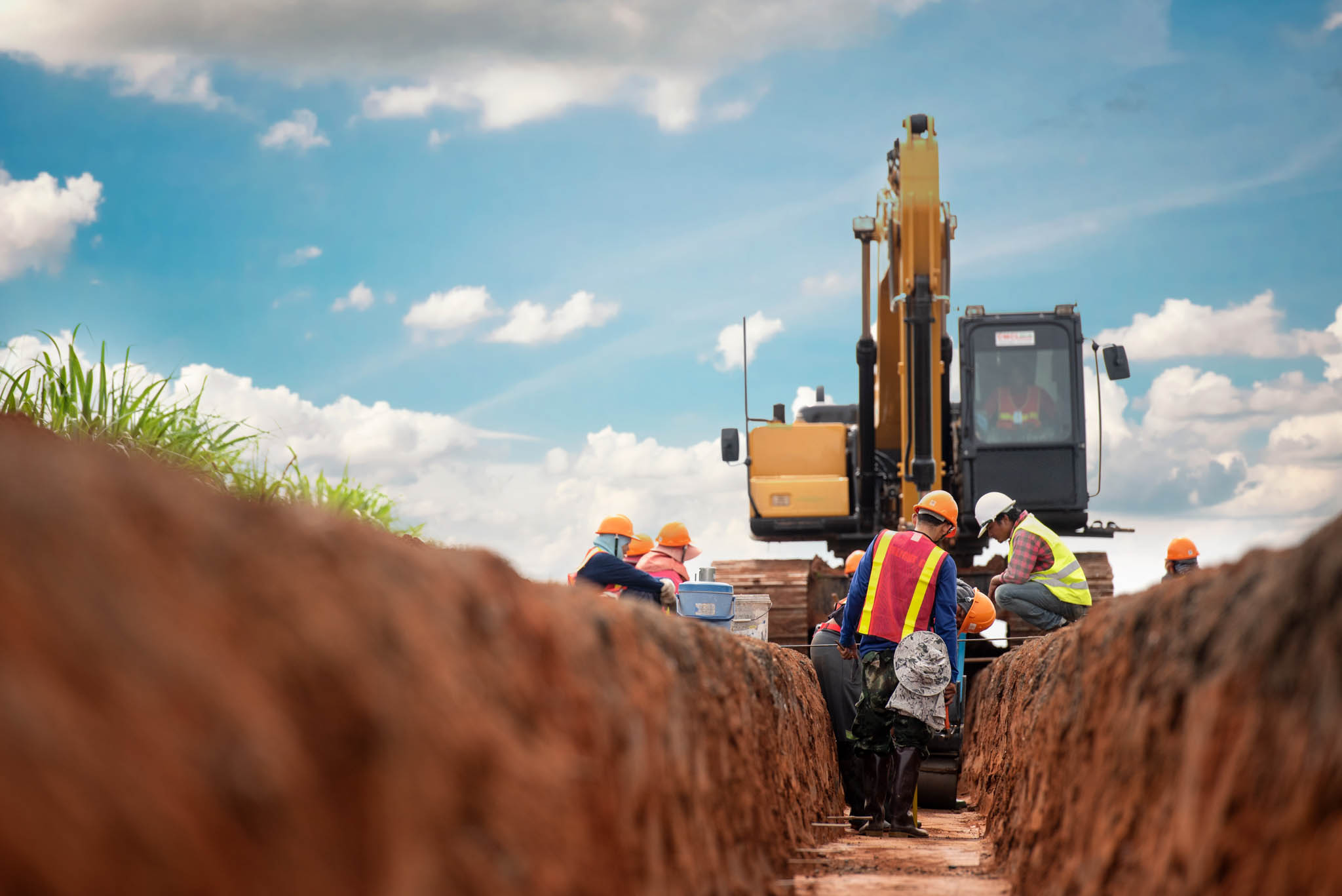 Construction workers working on a drainage trench.