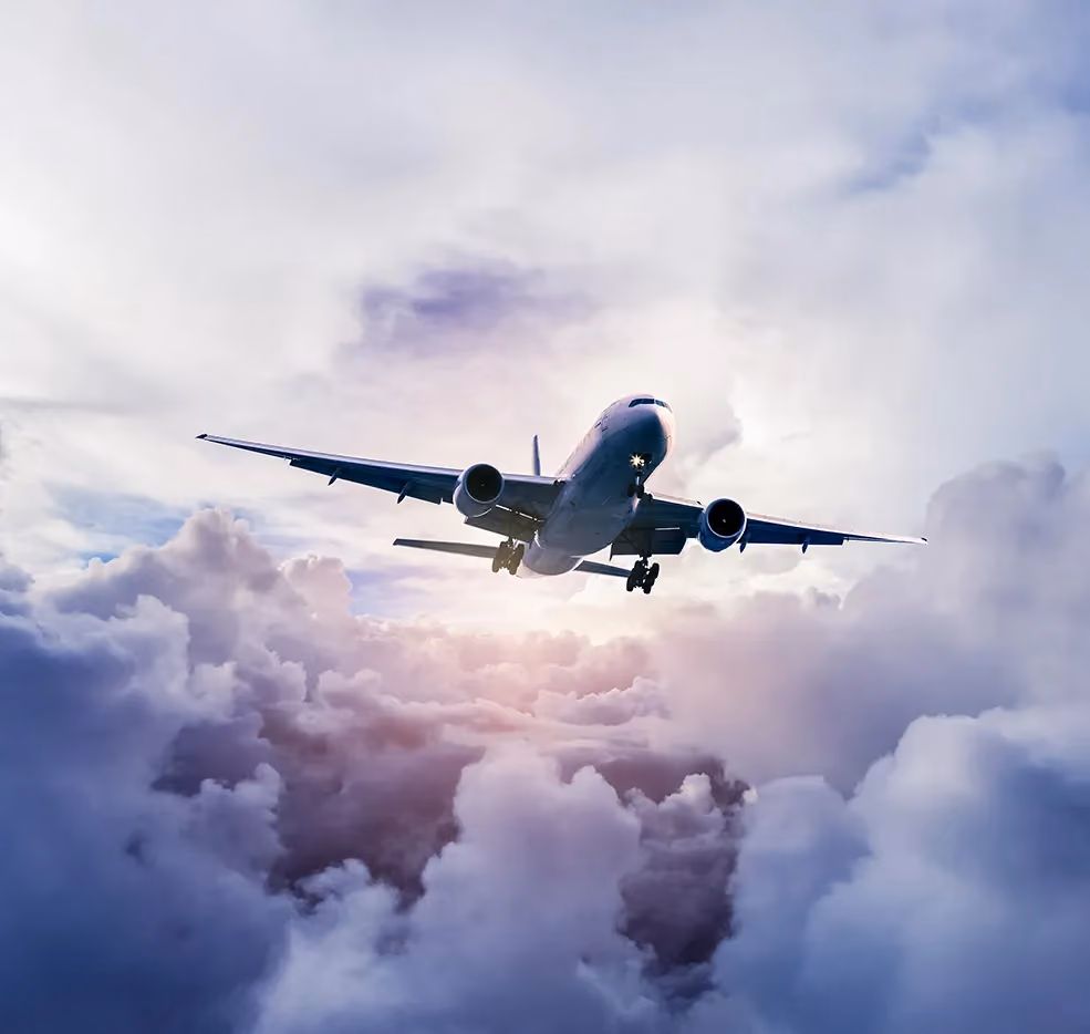 Plane flying over morning clouds.