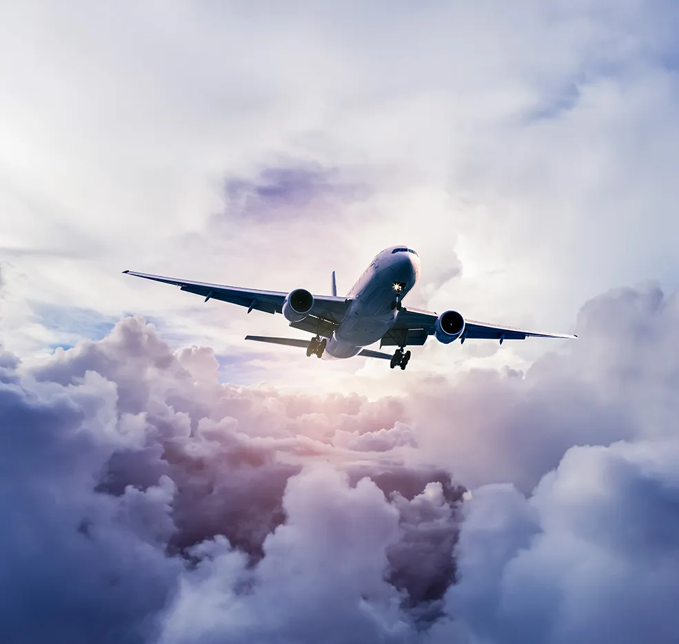 Plane flying over morning clouds.