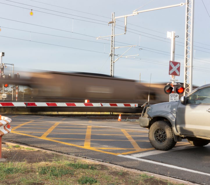 Train going through a rail level crossing.