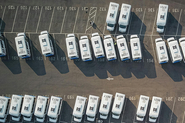 Aerial view of parking lot with fleet vehicles in numbered parking spots