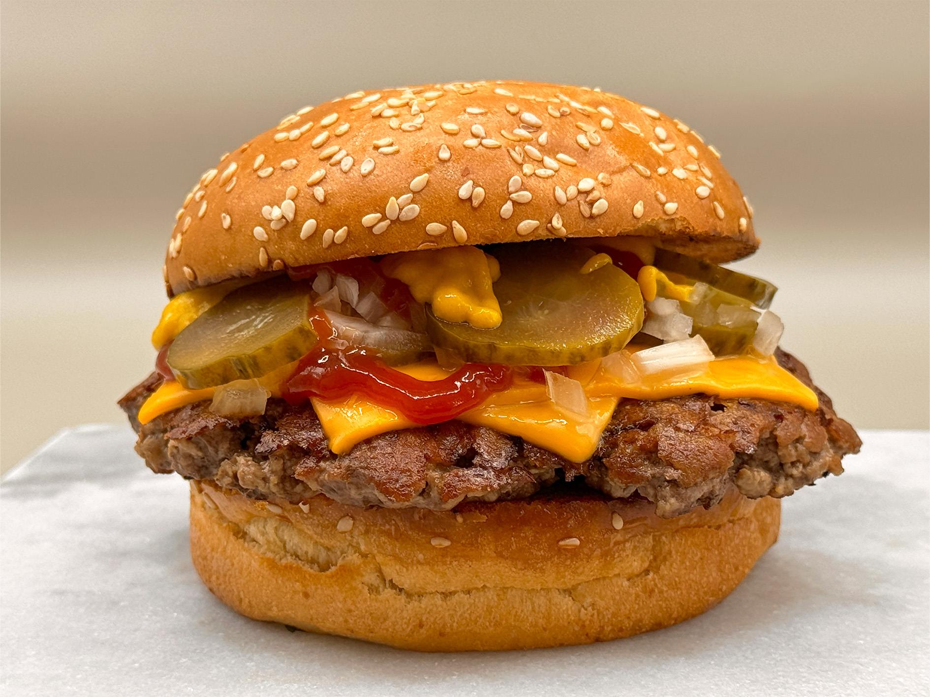 Burger with fried fries on black plate with sauce on the side