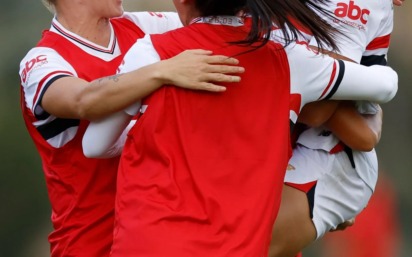 A group of women playing soccer.
