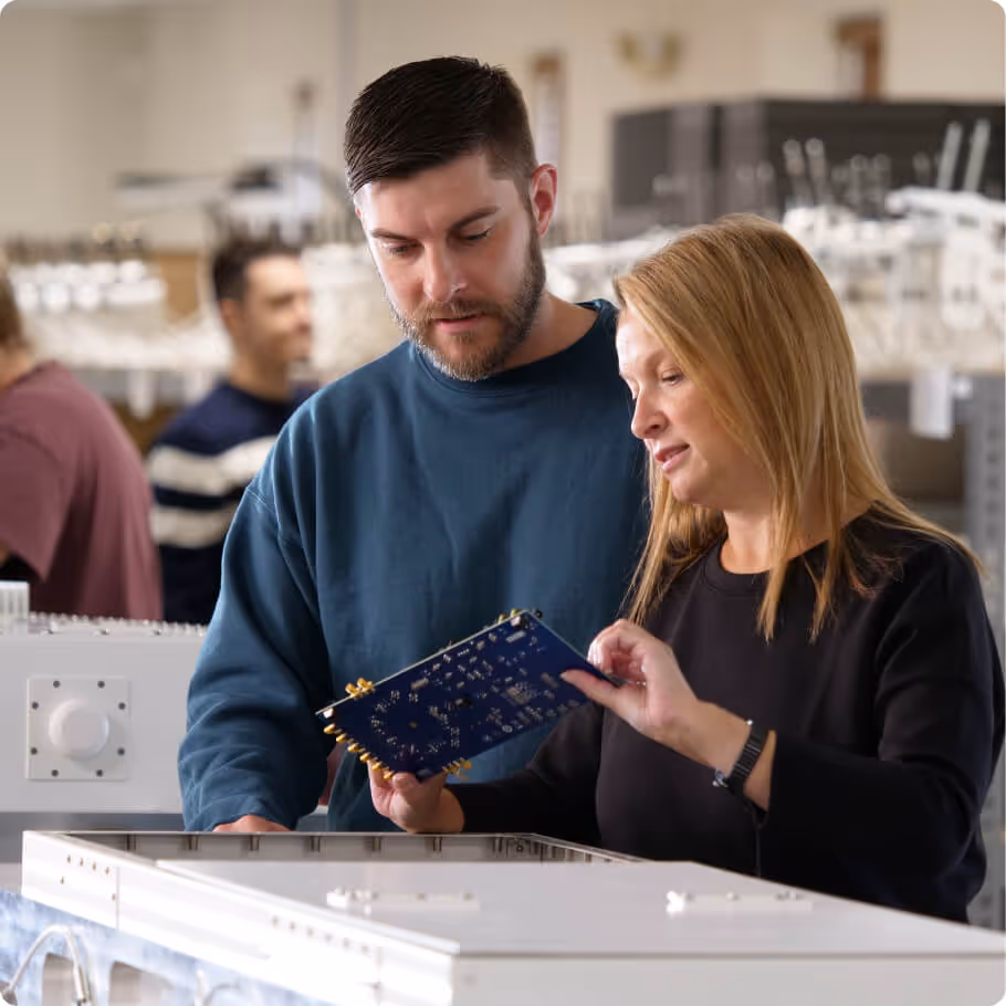 Two people discussing a piece of hardware