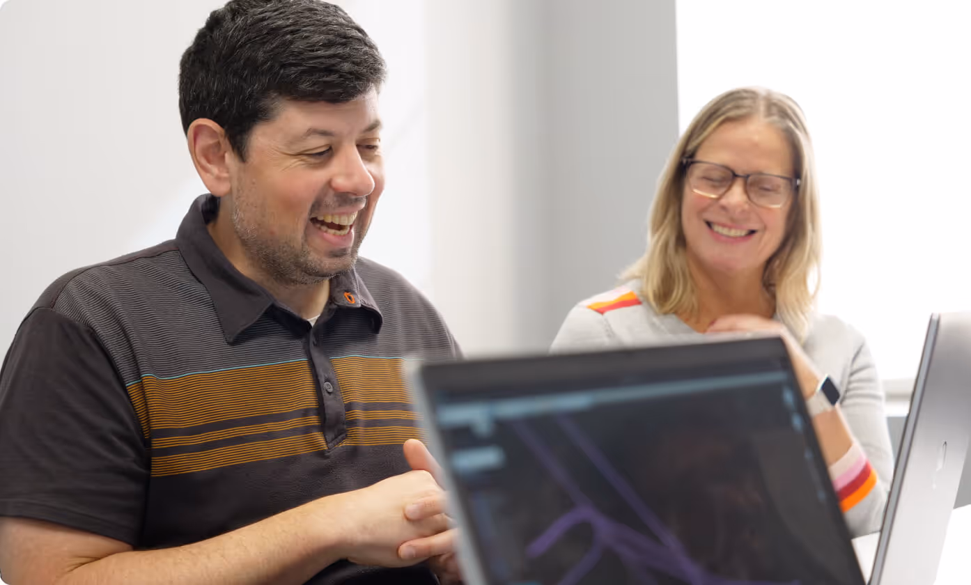 Two people smiling in an office 