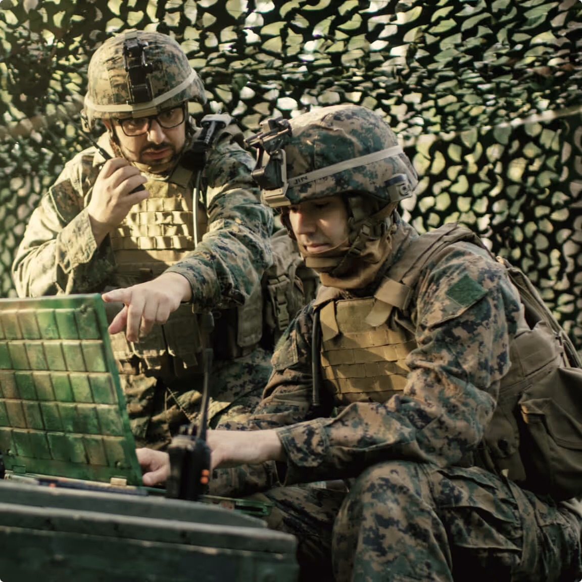Army people staring at a computer