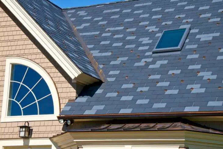 Modern house with a slate roof and skylight.