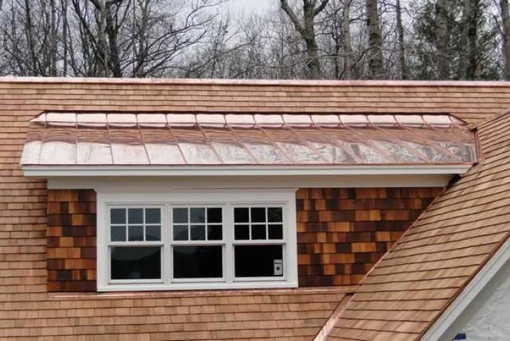 Cedar shake roof with a distinctive dormer window.