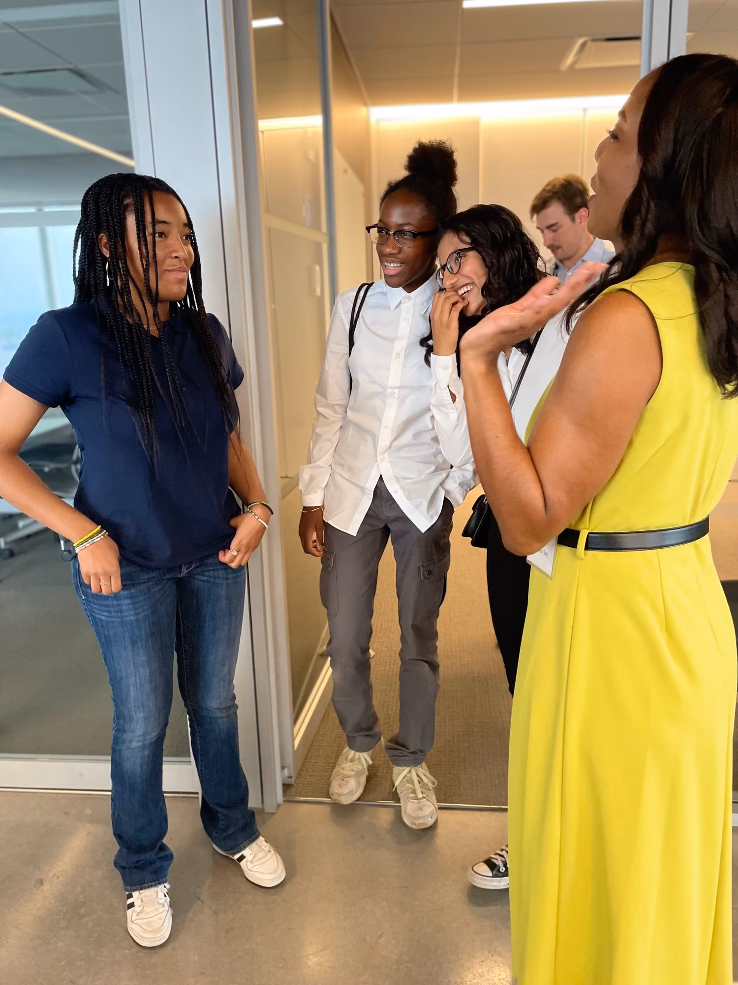 Students and adults conversing together during a school visit