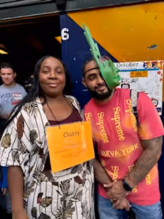 Three students posing together holding certificates or documents