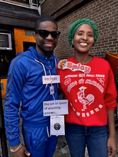 Two community members wearing name badges at a school event