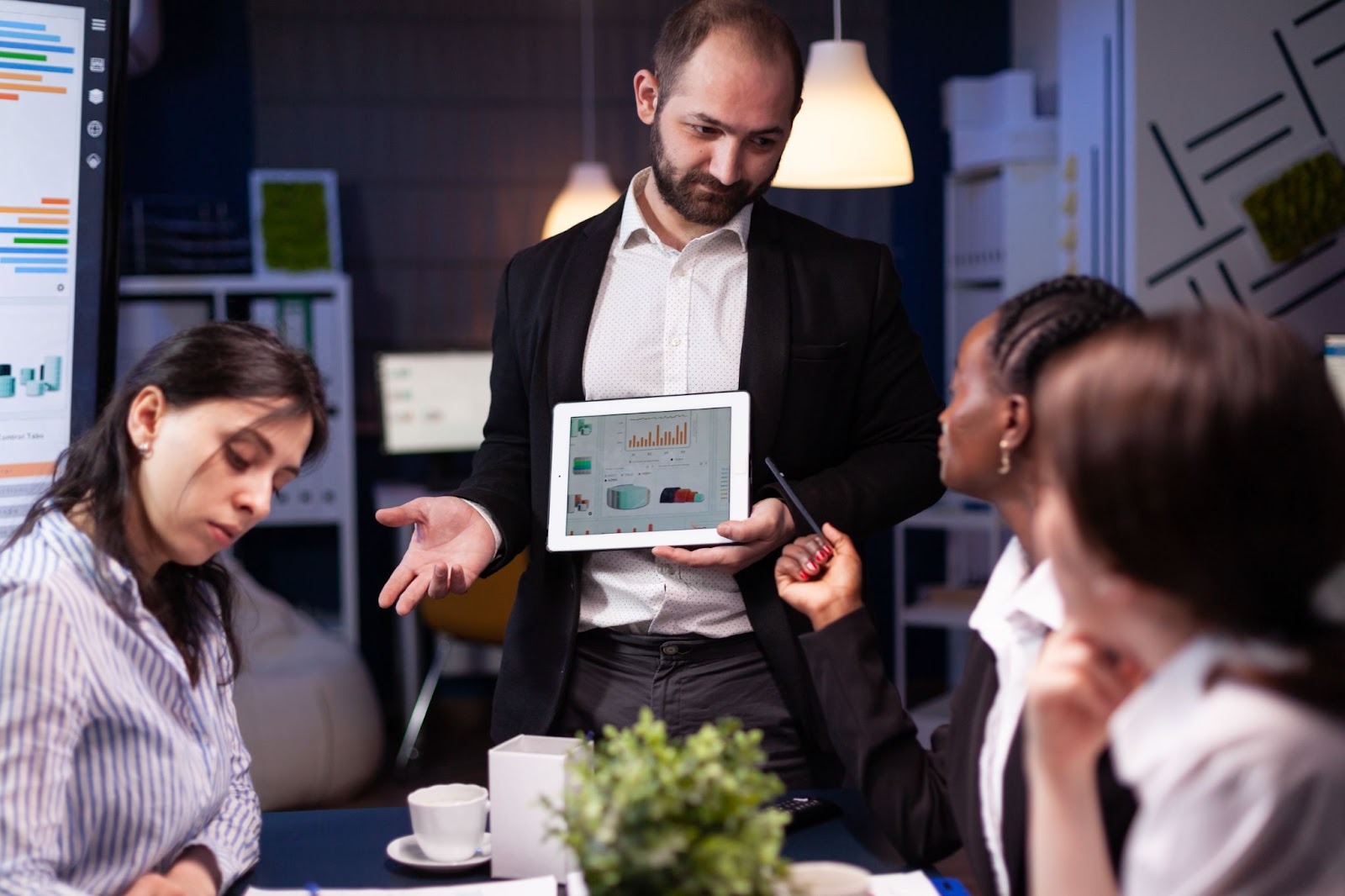 Team members using workforce management software on a computer to manage tasks and track employee performance.
