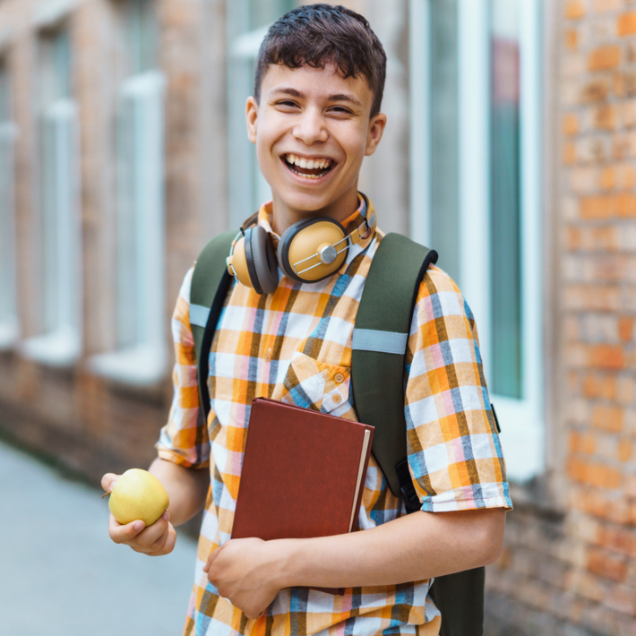 A healthy teenage boy holding a notebook
