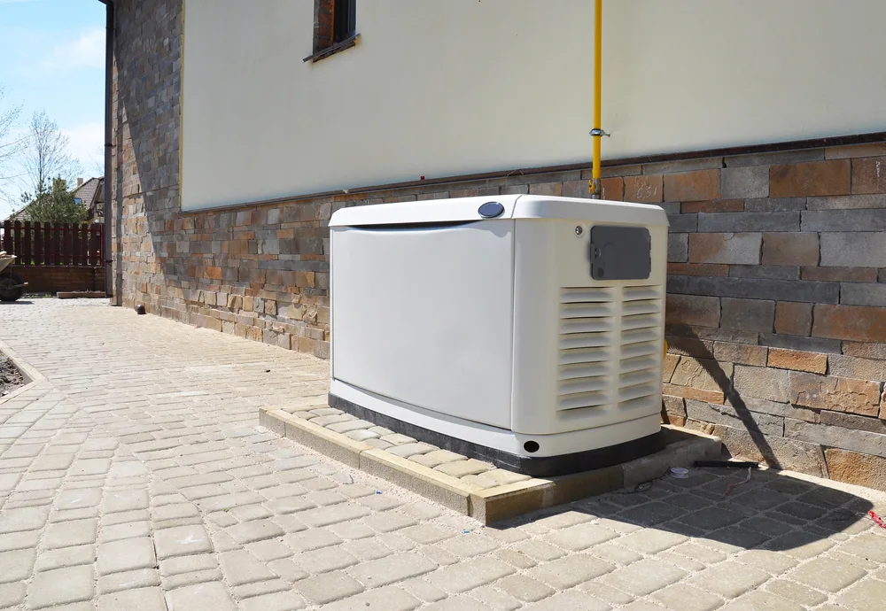 Large natural gas backup generator installed outside a residential home.