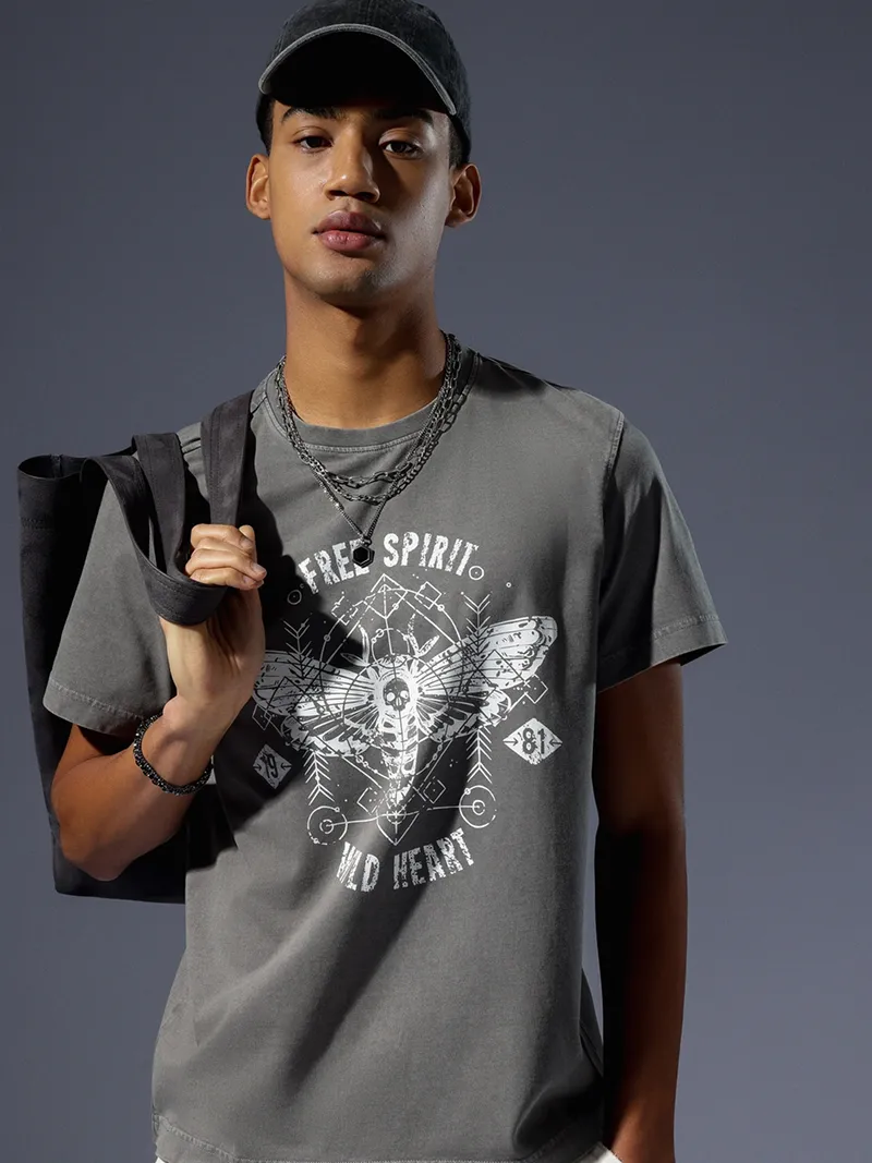 Male model in a grey graphic t-shirt and black cap.
