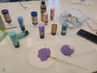 Senior painting rocks for a social and cognitive activity. 