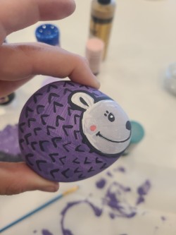 A completed rock painted as a hedgehog.
