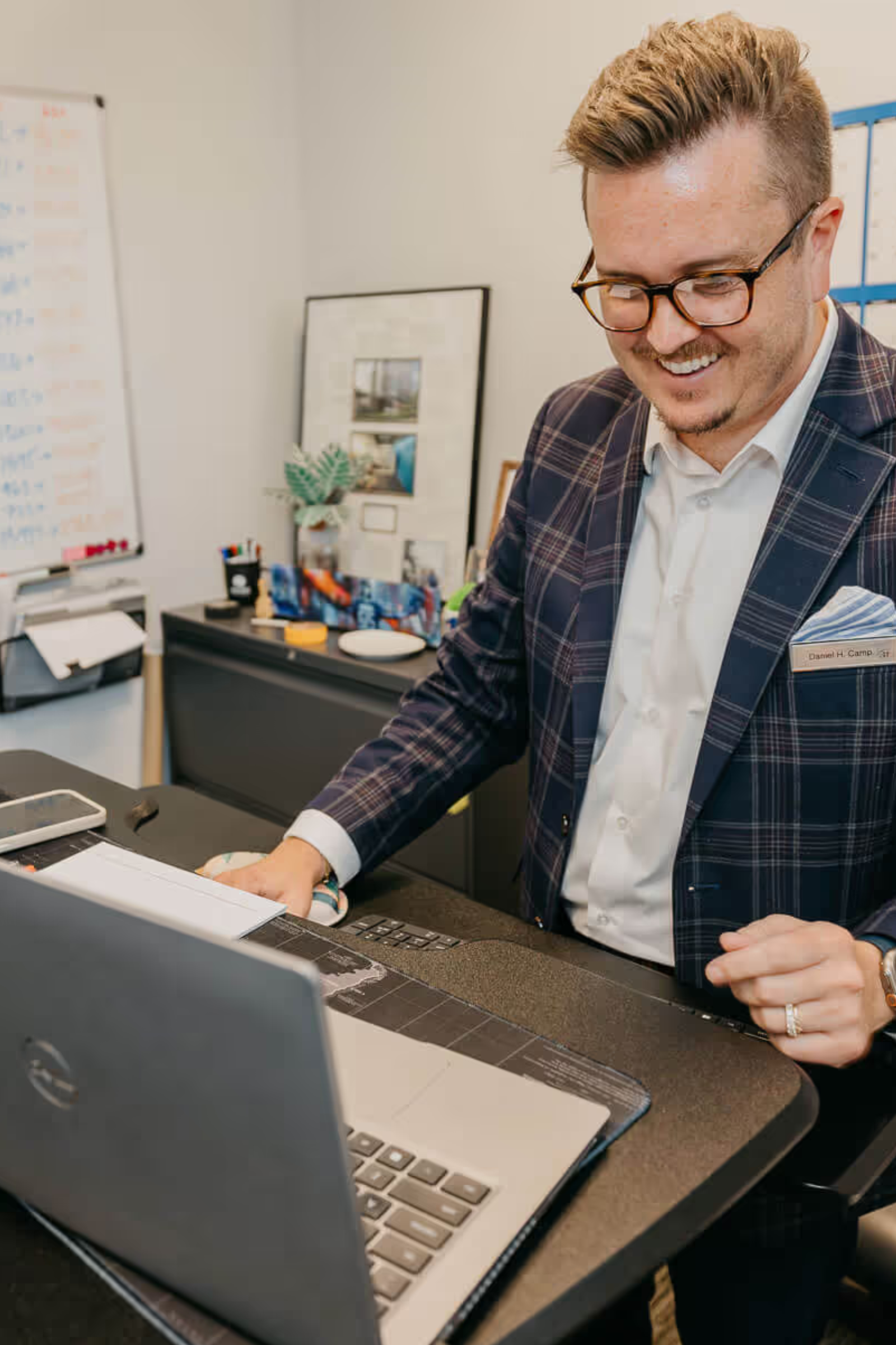 Hotel manager reviewing operational reports and performance data on a laptop in an office setting.