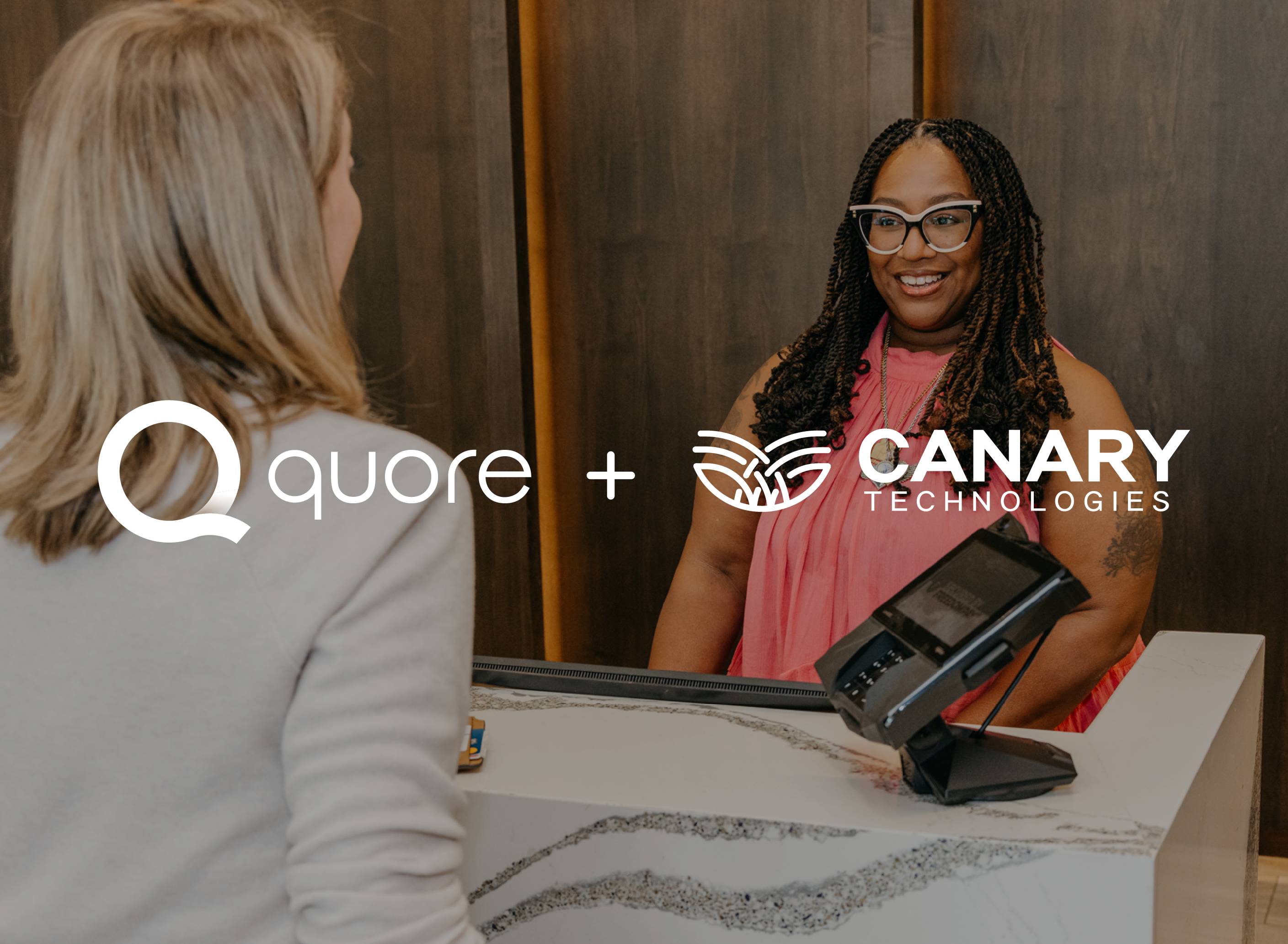 Hotel guest speaking with a front desk team member.