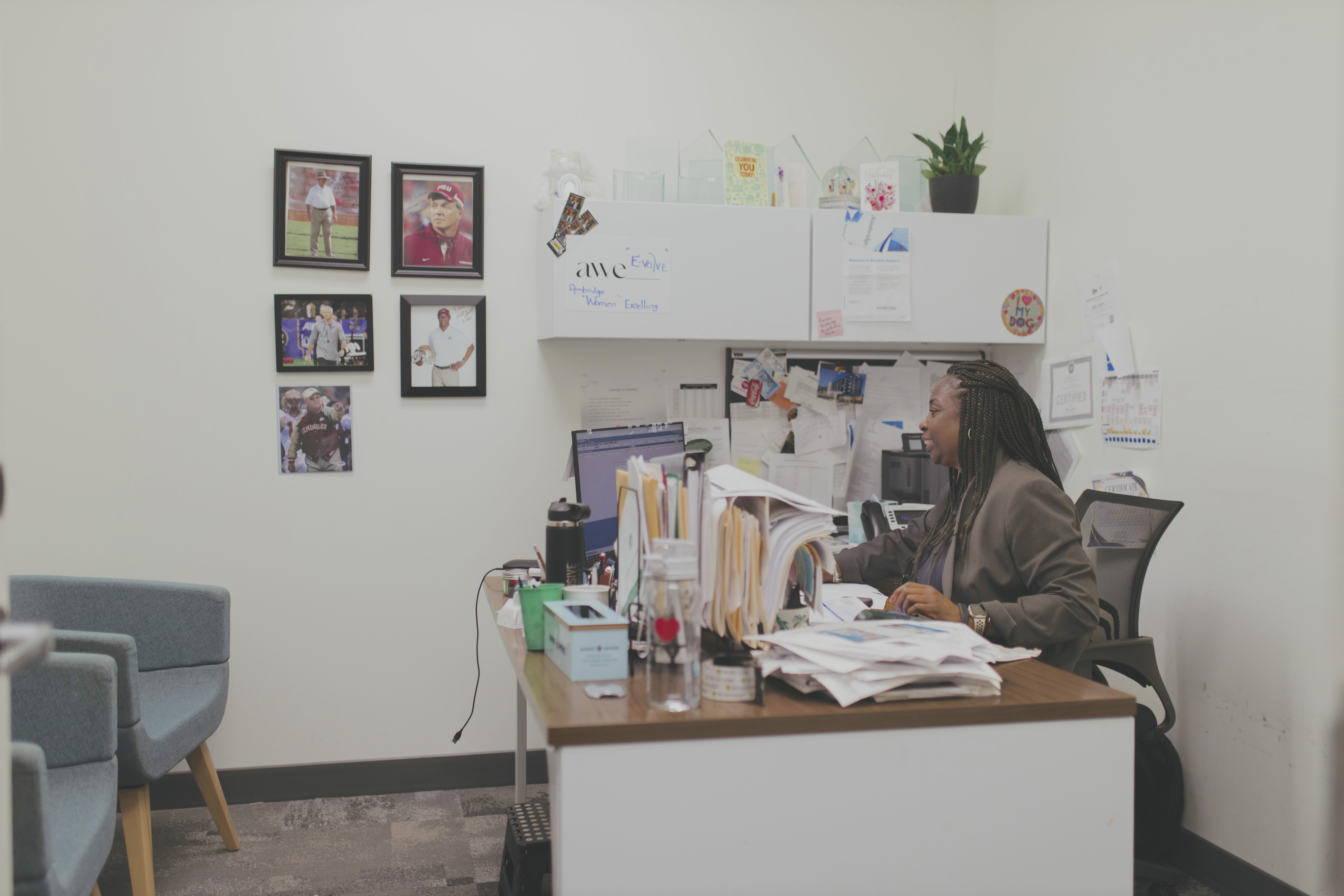 Hotel manager reviewing operational documents and reports at a desk in an office environment.