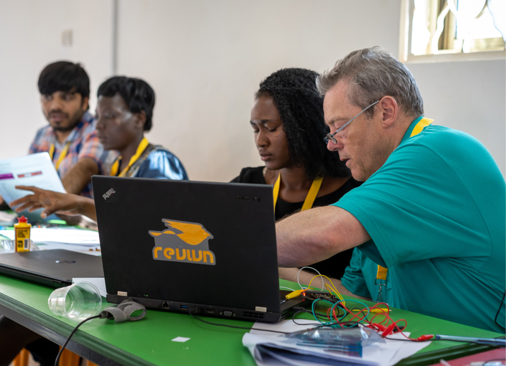 Man and woman working on a donated laptop