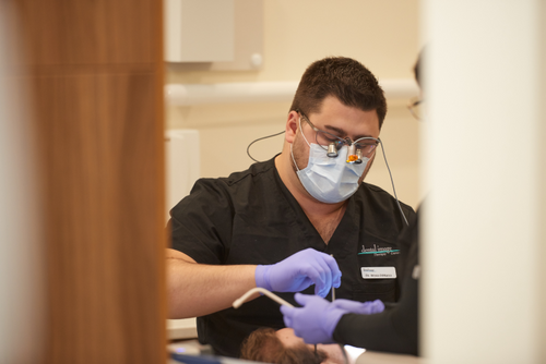 Dr. Bryan DiMarco performing a dental treatment