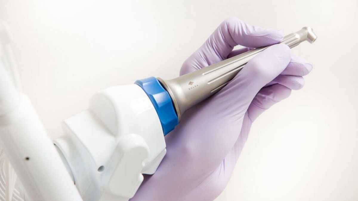 A closeup of a gloved hand holding a Solea Laser