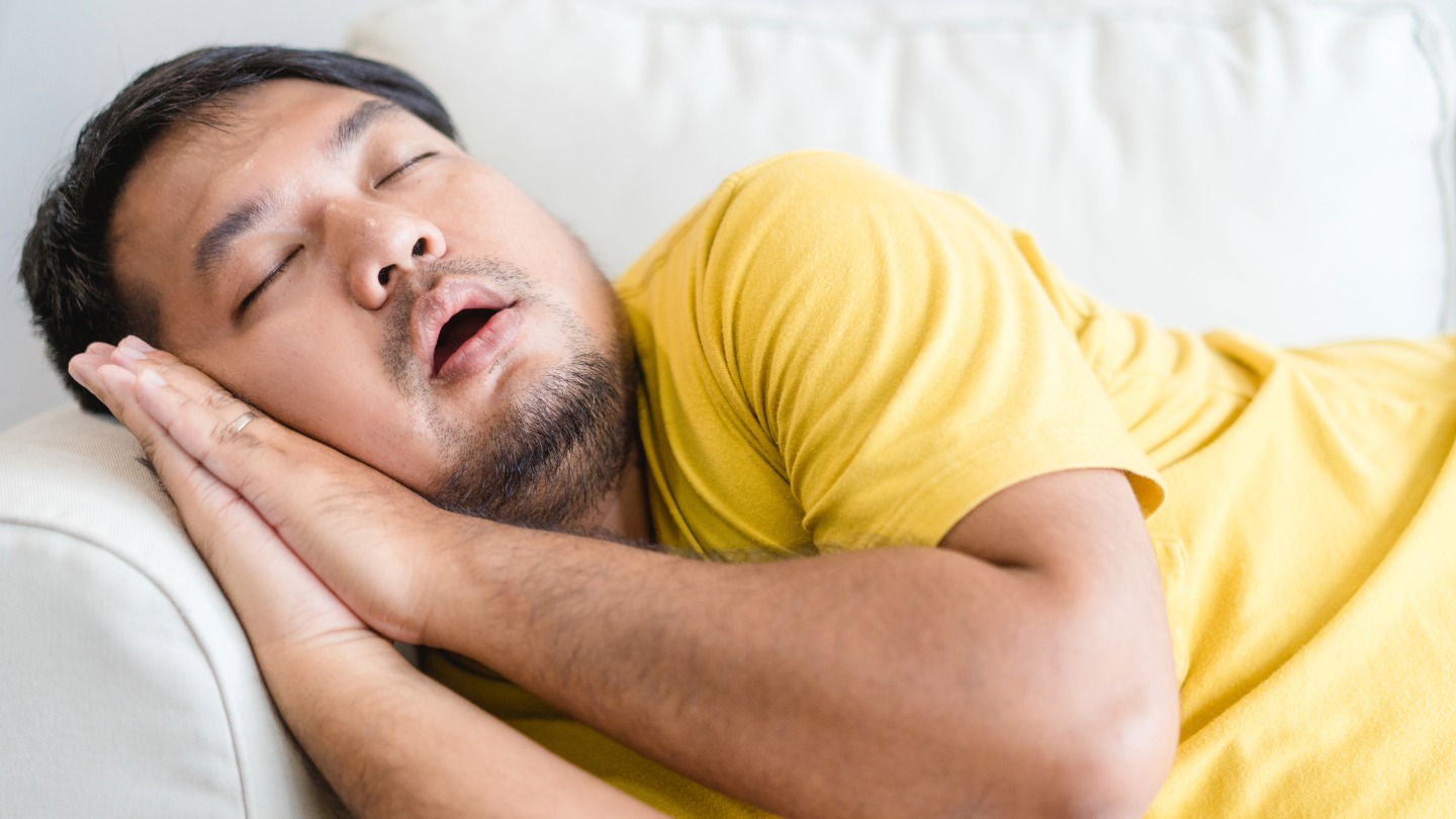 A man snoring on the couch
