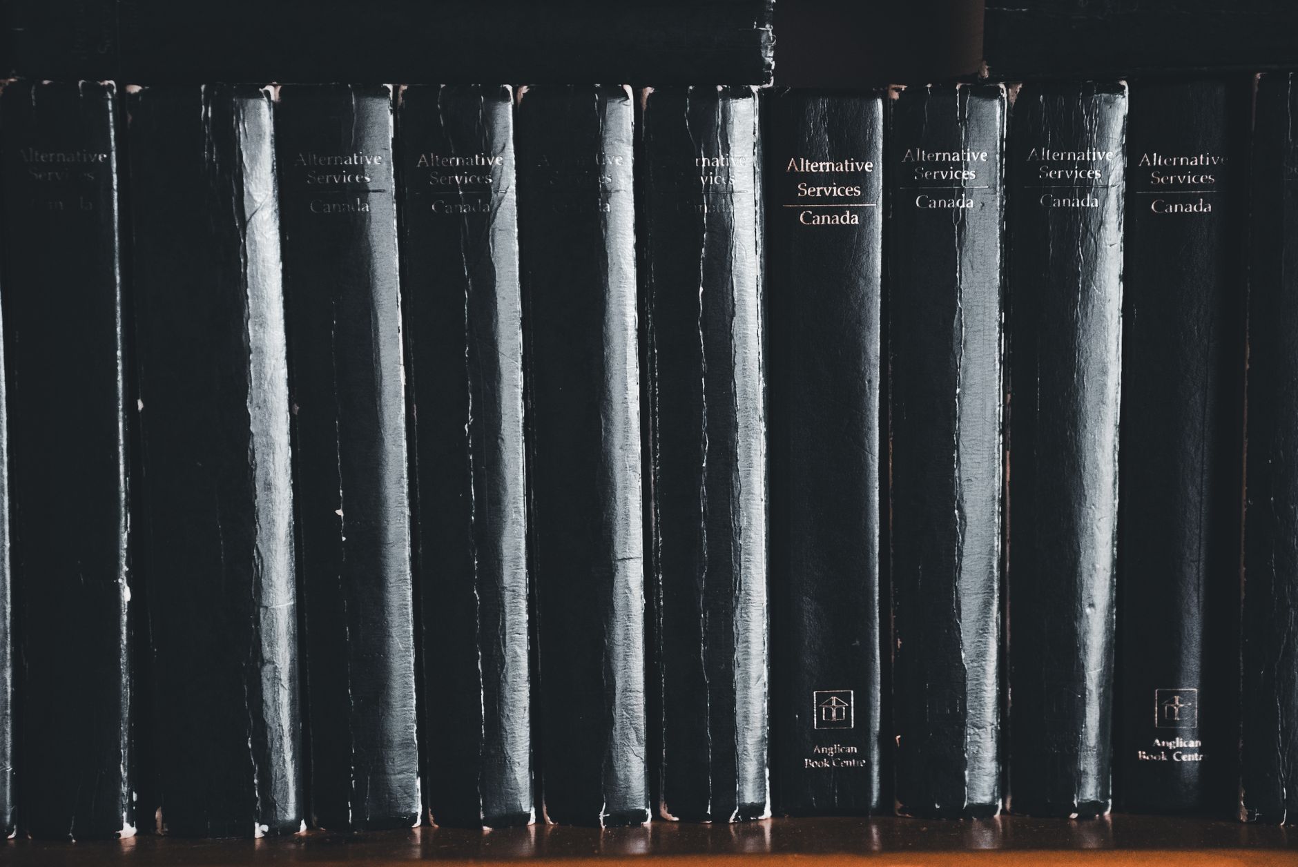 Black law books on a shelf, representing the current regulatory frameworks governing AI use in Australian legal practice.