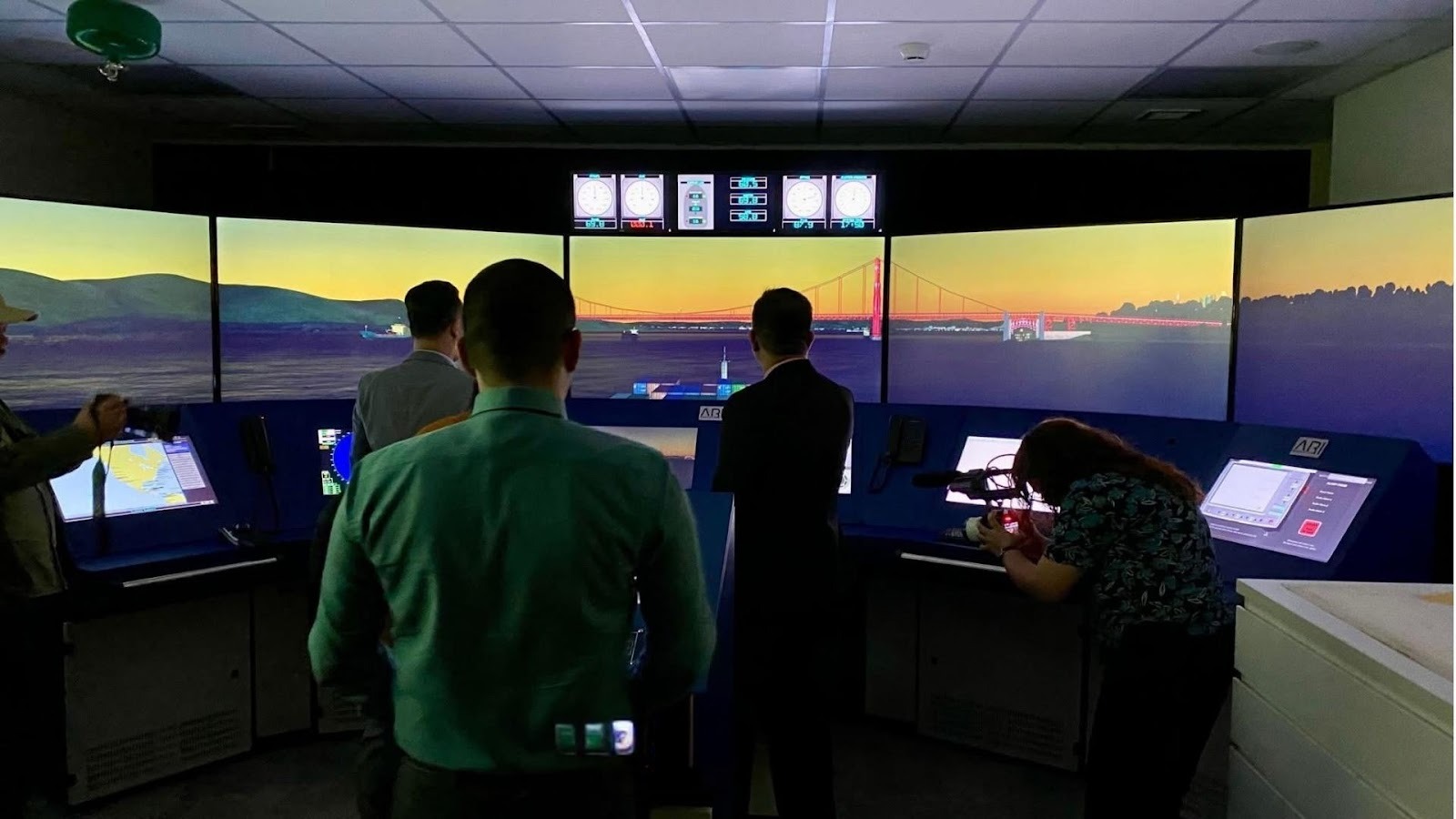 A group of people in a control roomAI-generated content may be incorrect.