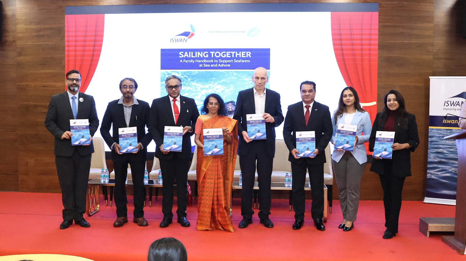 A group of people standing on a stageAI-generated content may be incorrect.