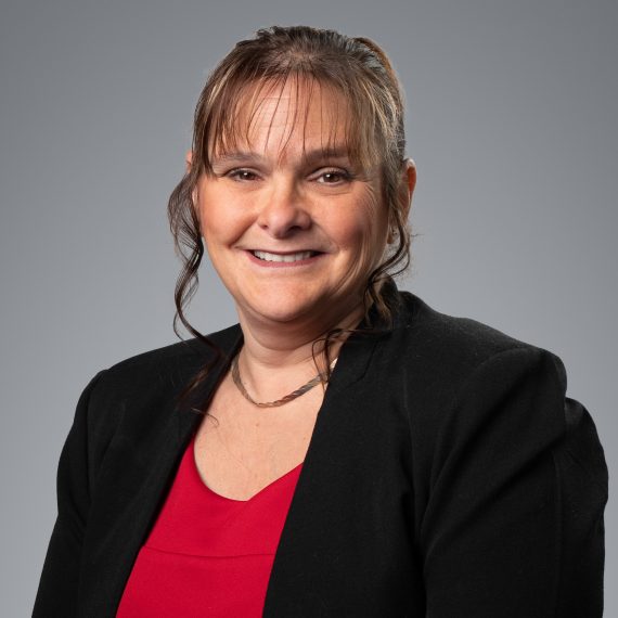 Smiling RTC IT professional in business attire representing managed IT support services in Burlington Ontario
