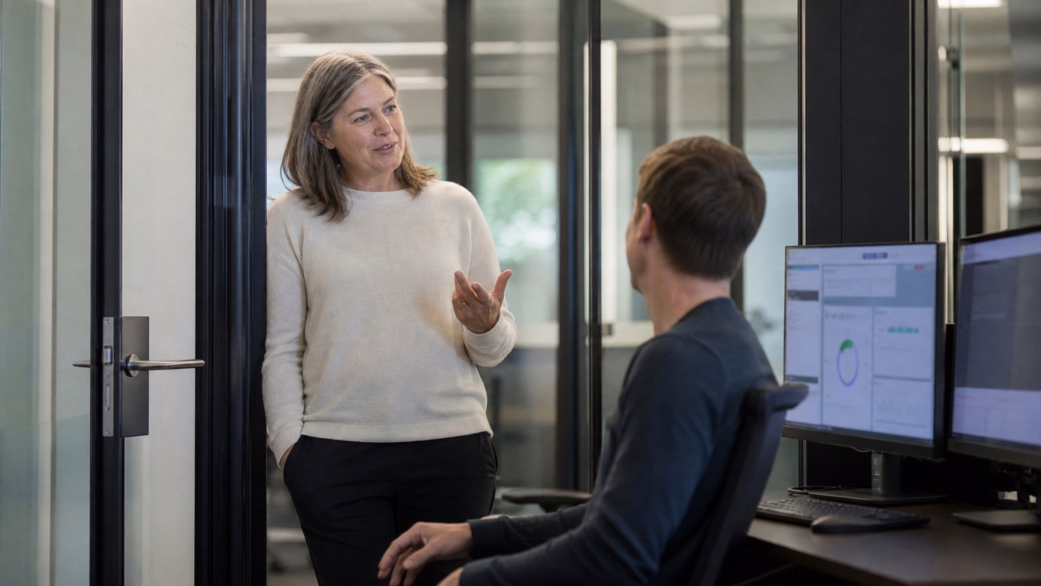 Business partners discussing strategy in office doorway