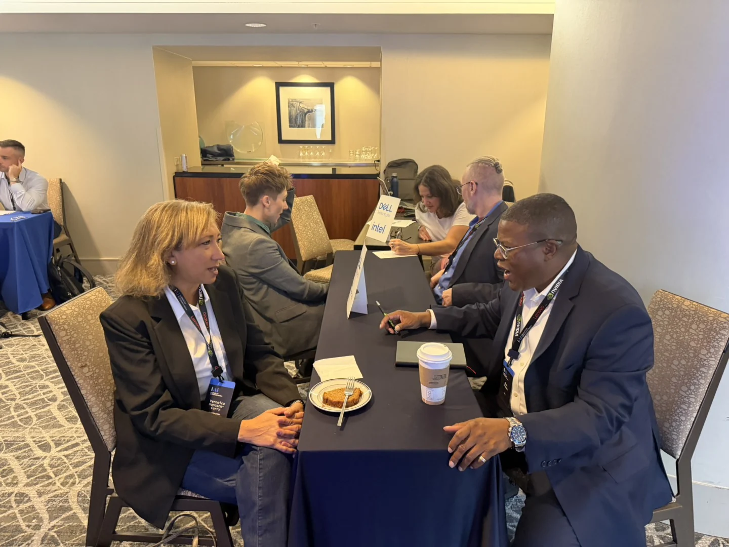 Two attendees meeting across a partner table at the Chicago 2026 summit
