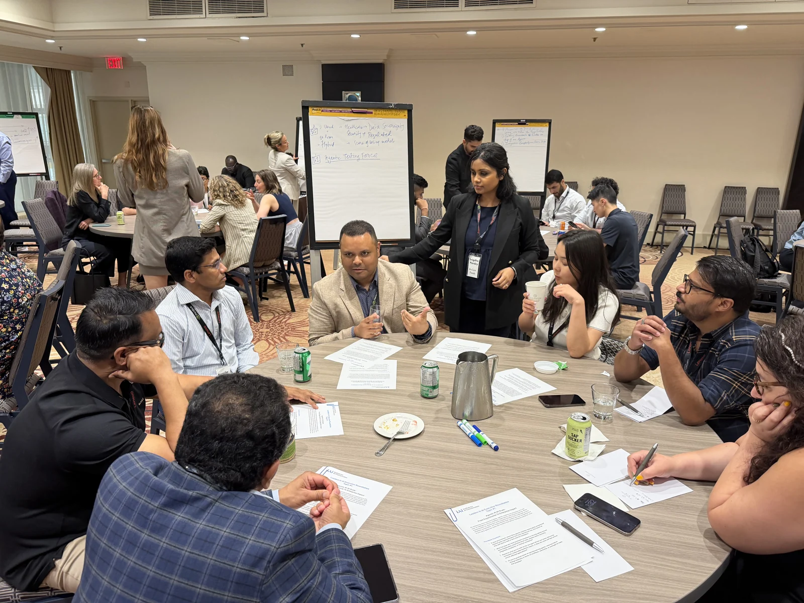 Executives discussing their perspectives around a table at the Toronto 2026 summit