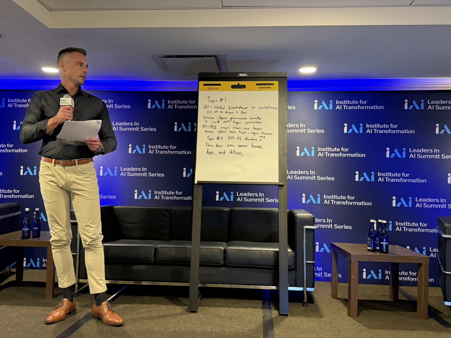An executive sharing his table's findings with the audience at the Chicago Leaders in AI summit.