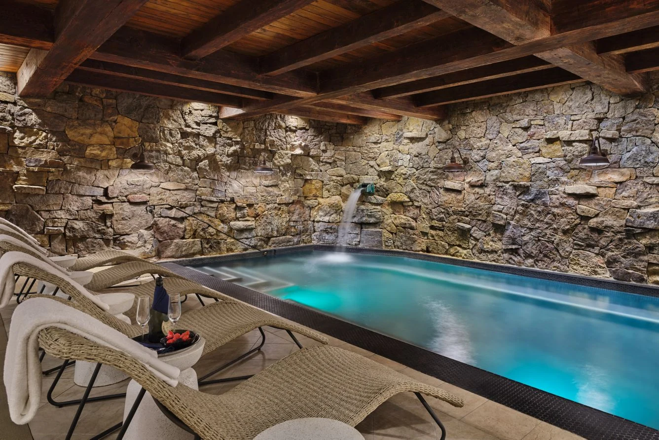 The stone grotto pool and lounge chairs at The Ritz-Carlton Bachelor Gulch spa