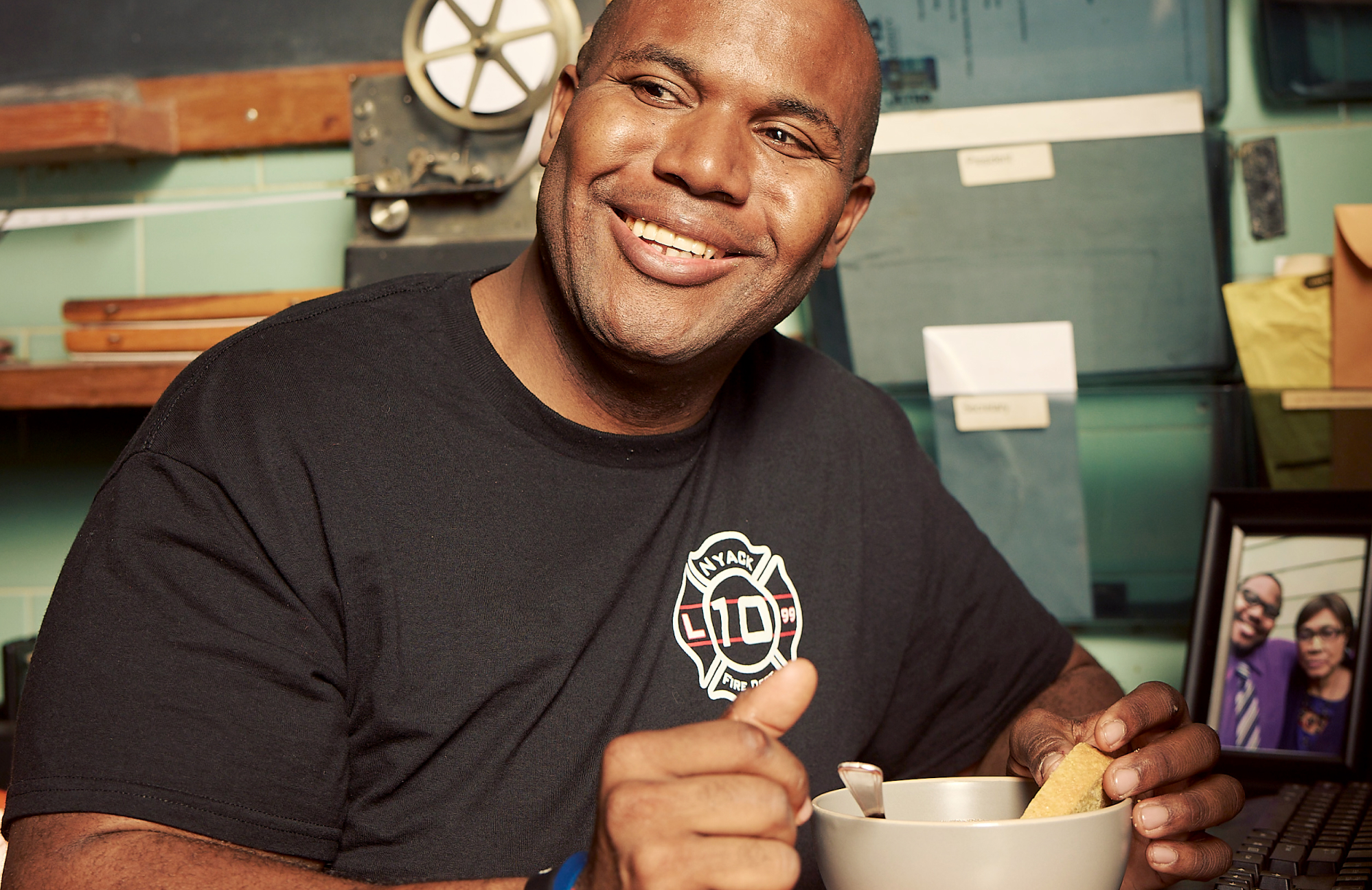a man smiling and eating