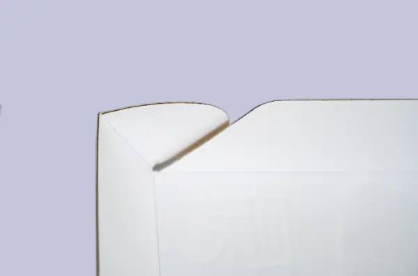 Close-up view of the tuck flap detail with embossed UV printing on a food-grade cake roll corrugated mailer box